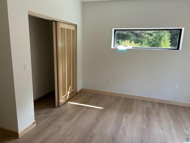 unfurnished bedroom featuring hardwood / wood-style flooring and a closet