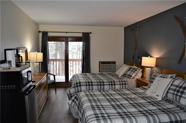 bedroom with dark wood-type flooring and access to outside