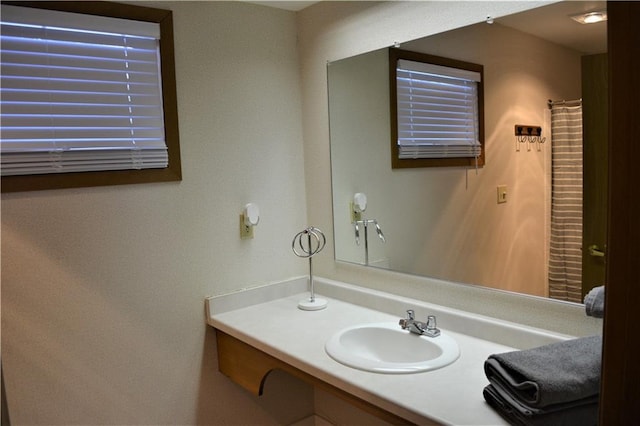 bathroom featuring vanity with extensive cabinet space