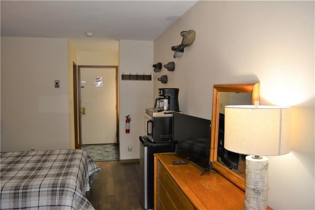 bedroom with dark hardwood / wood-style flooring