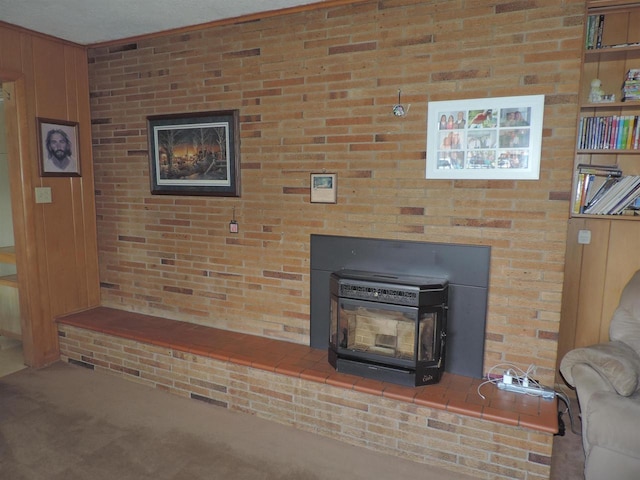 room details featuring a wood stove, wood walls, carpet floors, and a textured ceiling