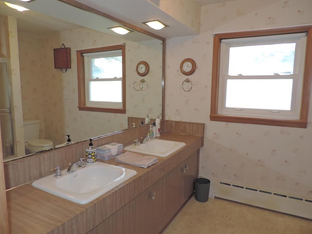 bathroom with vanity, toilet, and baseboard heating