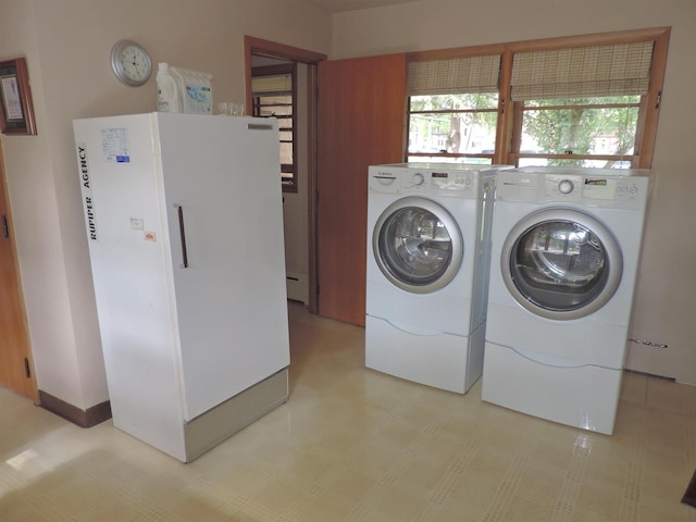 washroom featuring separate washer and dryer and a baseboard radiator