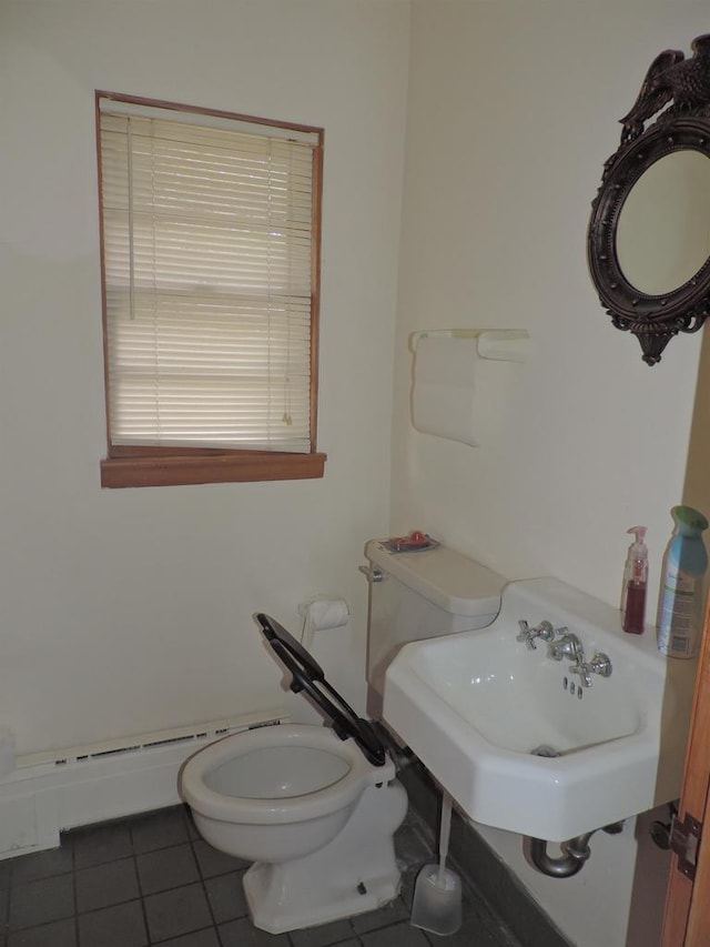 bathroom featuring tile patterned flooring, toilet, and sink