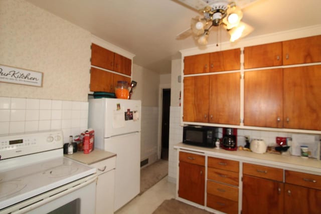 kitchen featuring backsplash, white appliances, tile walls, and ceiling fan