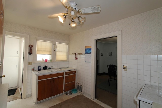 interior space with tile walls, tasteful backsplash, tile floors, and ceiling fan