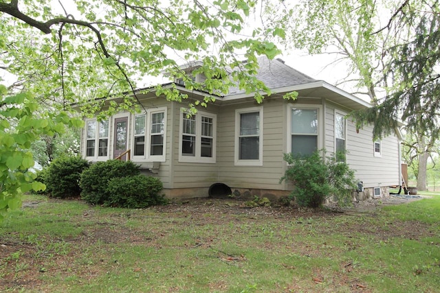 view of side of property with a yard