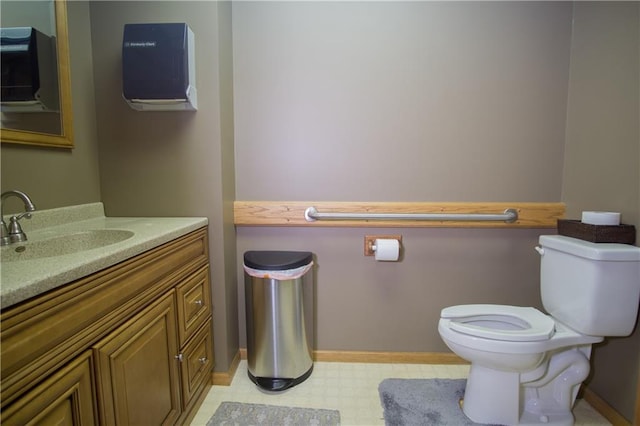 bathroom with toilet, tile flooring, and vanity