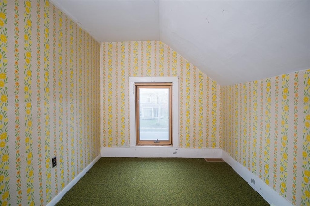 bonus room with lofted ceiling and carpet