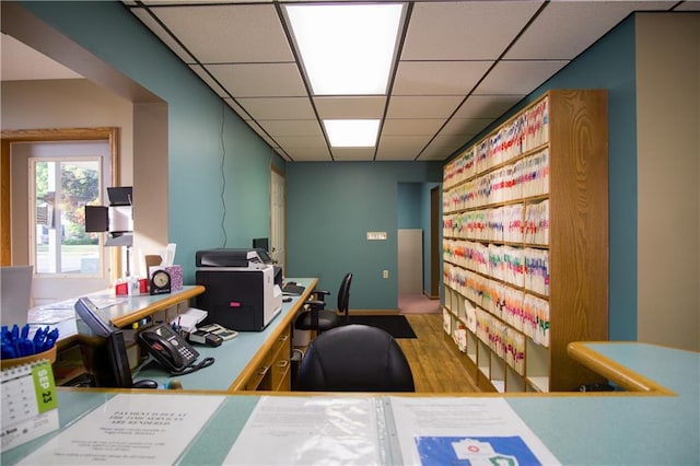 home office featuring hardwood / wood-style floors and a drop ceiling