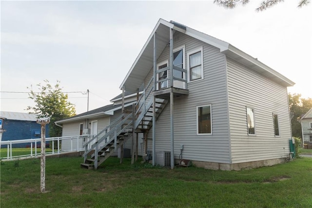 back of house with a lawn