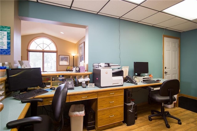 office space with a paneled ceiling and light hardwood / wood-style floors