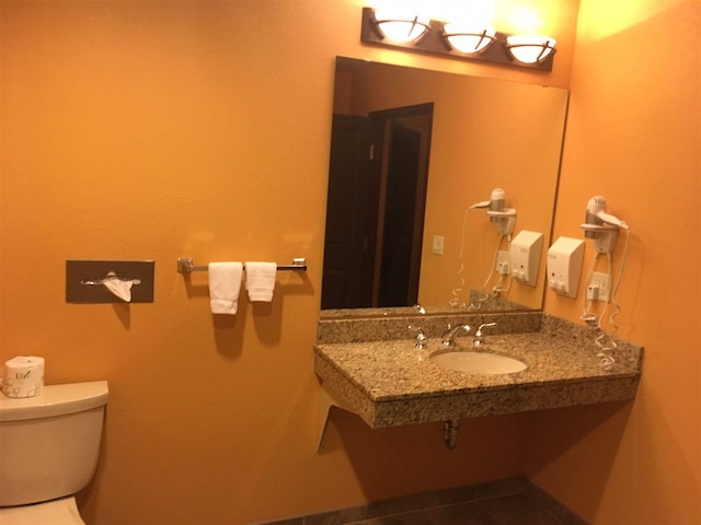 bathroom featuring tile floors, toilet, and vanity