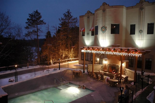 pool at night with a patio