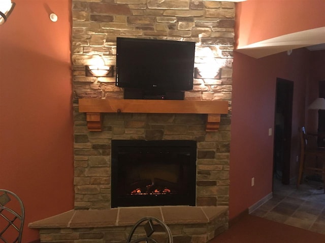 interior details featuring tile flooring and a stone fireplace