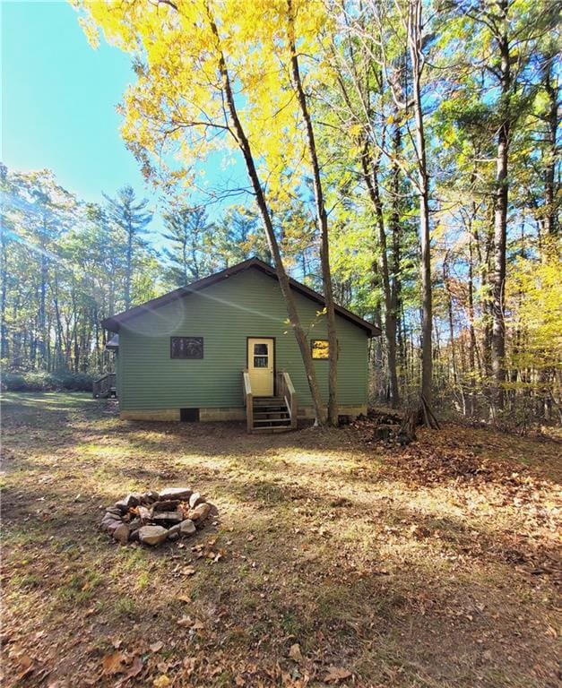 back of property with a fire pit