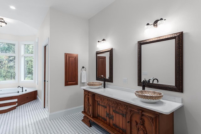 bathroom featuring a tub, tile floors, vanity, and vaulted ceiling