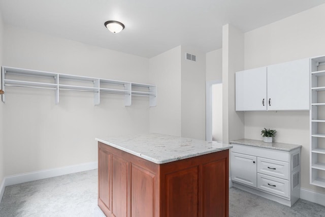 spacious closet featuring light carpet