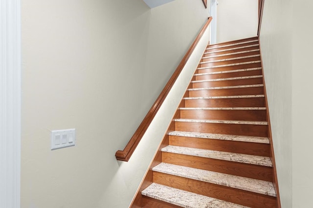 staircase with wood-type flooring