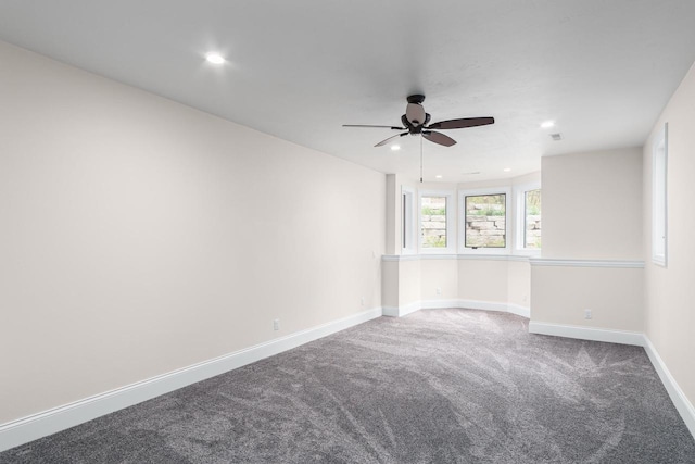 carpeted spare room with ceiling fan