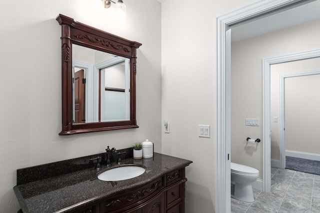 bathroom featuring tile flooring, large vanity, and toilet