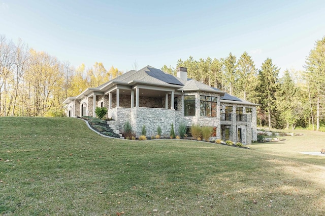 view of home's exterior featuring solar panels and a lawn