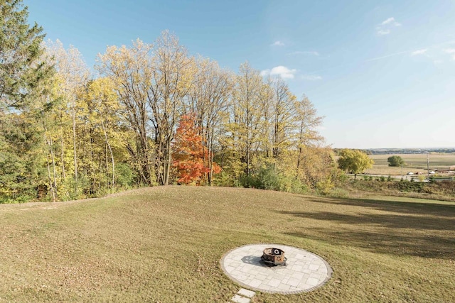 view of yard with a fire pit