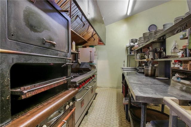 kitchen with double oven range and light tile floors