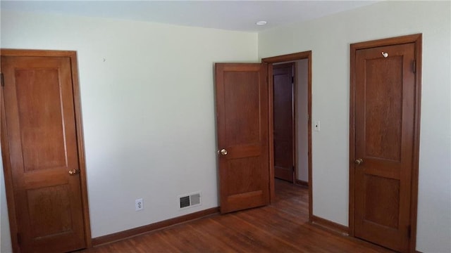 unfurnished bedroom featuring dark hardwood / wood-style flooring