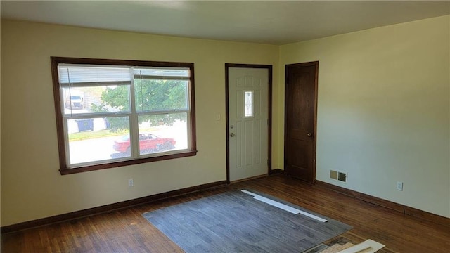 unfurnished room with dark hardwood / wood-style flooring