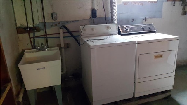 laundry room with washing machine and clothes dryer and sink