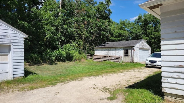 view of yard with a garage and an outdoor structure