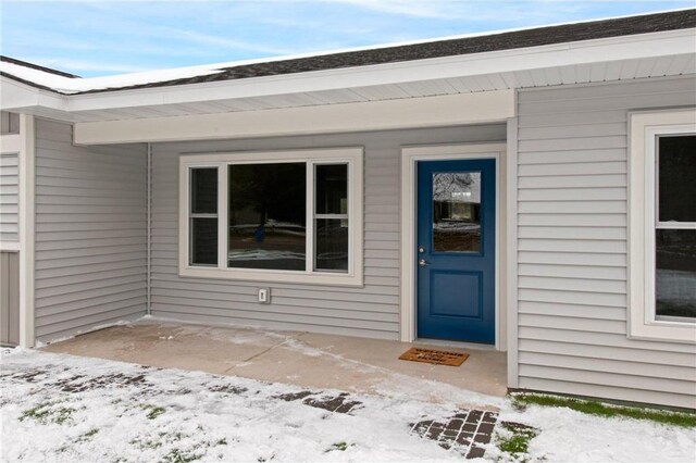 view of snow covered property entrance