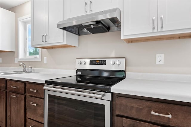 kitchen with exhaust hood, electric stove, sink, dark brown cabinetry, and white cabinetry