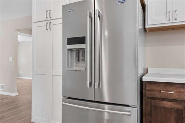 kitchen with light hardwood / wood-style flooring, white cabinetry, and high end fridge