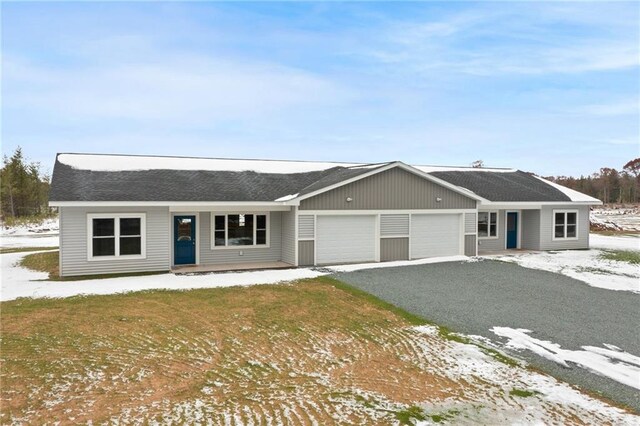 ranch-style house with a lawn and a garage