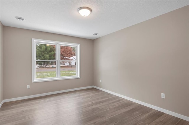 spare room with light wood-type flooring