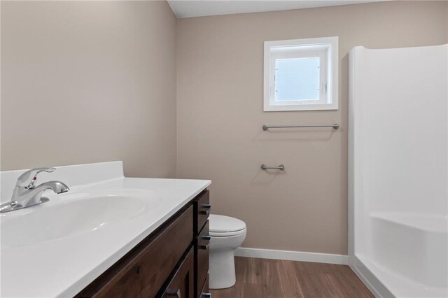 bathroom with vanity, hardwood / wood-style flooring, and toilet