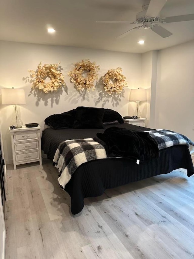 bedroom with ceiling fan and light wood-type flooring