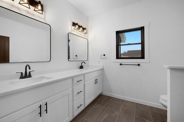 bathroom with tile flooring, double sink, toilet, and oversized vanity