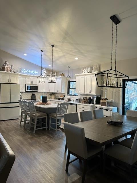 dining room featuring plenty of natural light, dark hardwood / wood-style floors, and a notable chandelier