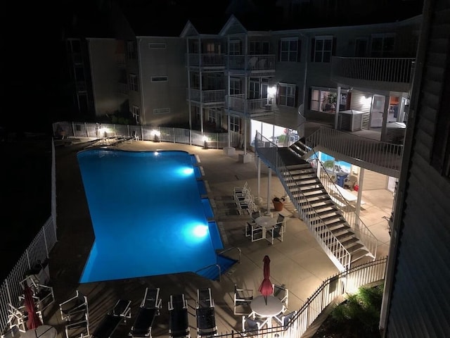 pool at twilight with a patio