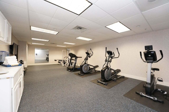 exercise room featuring a paneled ceiling