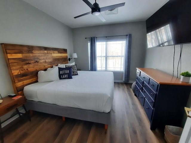 bedroom with ceiling fan and dark wood-type flooring