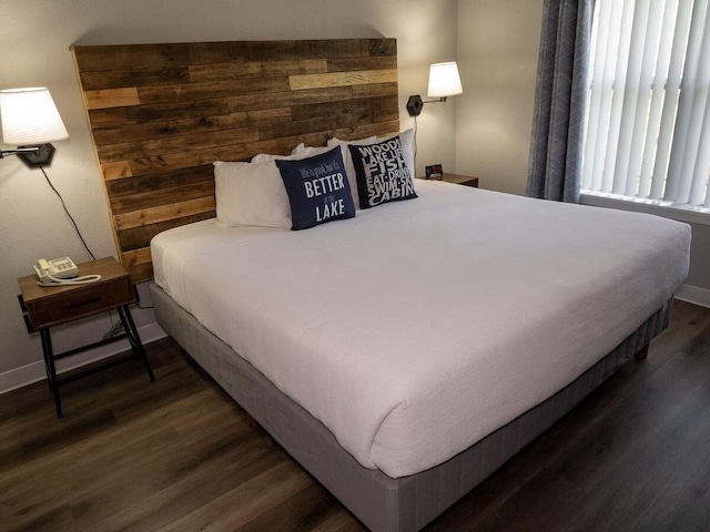 bedroom with dark wood-type flooring