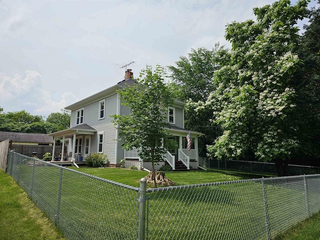 view of front of home with covered porch and a front yard