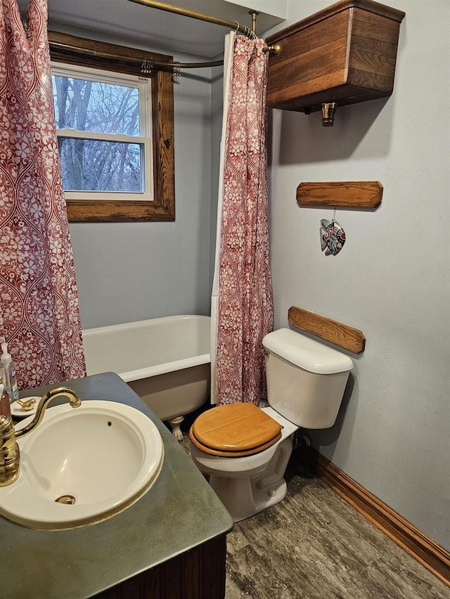 full bathroom featuring shower / bath combination with curtain, toilet, and sink