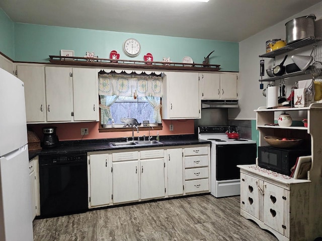 kitchen with white cabinetry, sink, black appliances, and light hardwood / wood-style floors