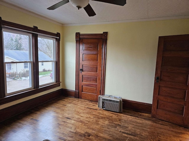 unfurnished room featuring crown molding, ceiling fan, a textured ceiling, and hardwood / wood-style flooring