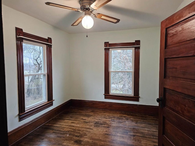 unfurnished room featuring ceiling fan, plenty of natural light, and dark wood-type flooring